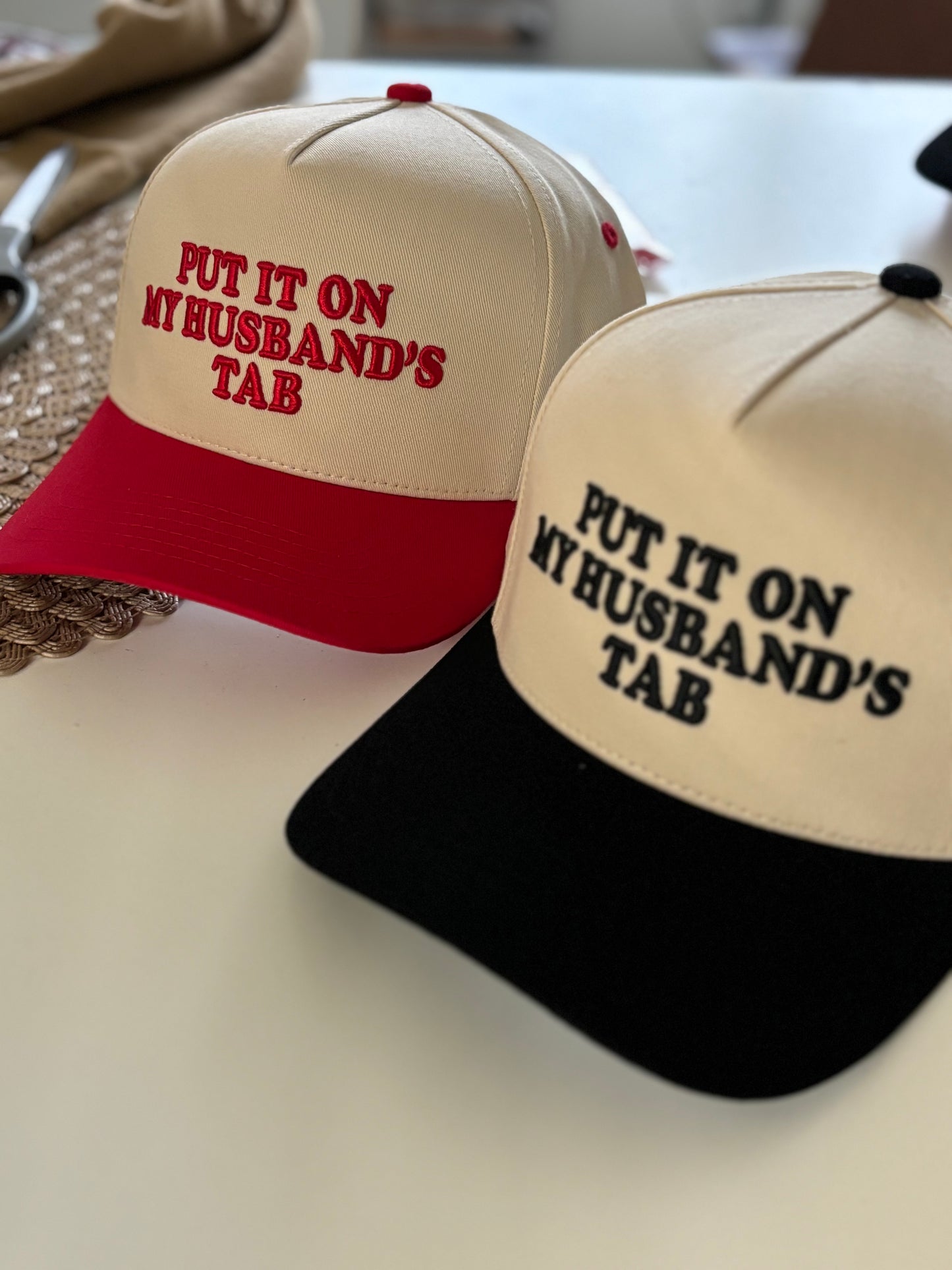 Put It on My Husband’s Tab” Embroidered Two-Tone Trucker Hat (6pk)
