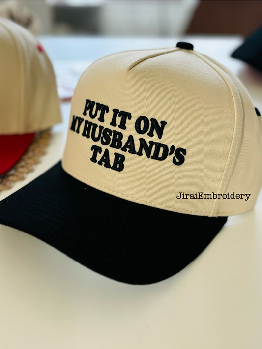 Put It on My Husband’s Tab” Embroidered Two-Tone Trucker Hat (6pk)